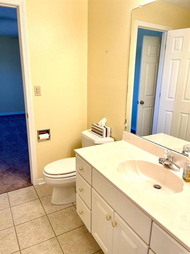 bathroom featuring tile patterned floors, toilet, and vanity