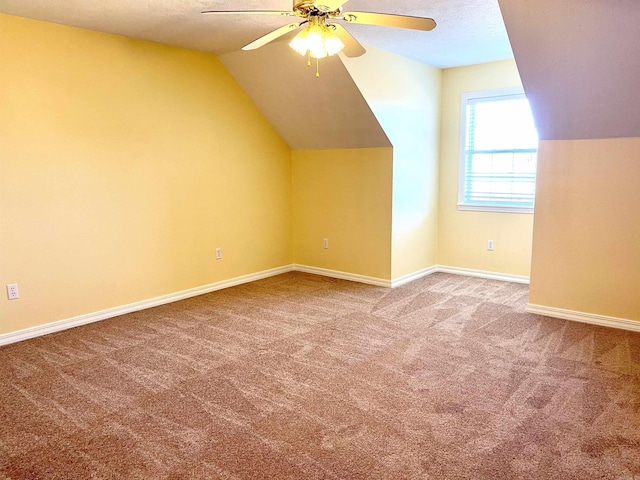 bonus room featuring lofted ceiling, carpet floors, and ceiling fan