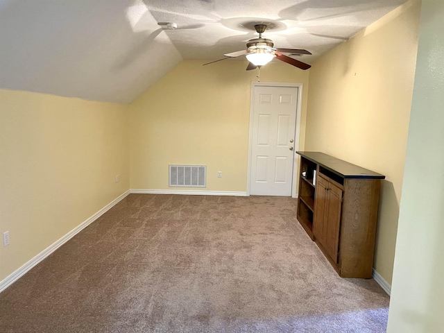 bonus room featuring lofted ceiling, light carpet, and ceiling fan