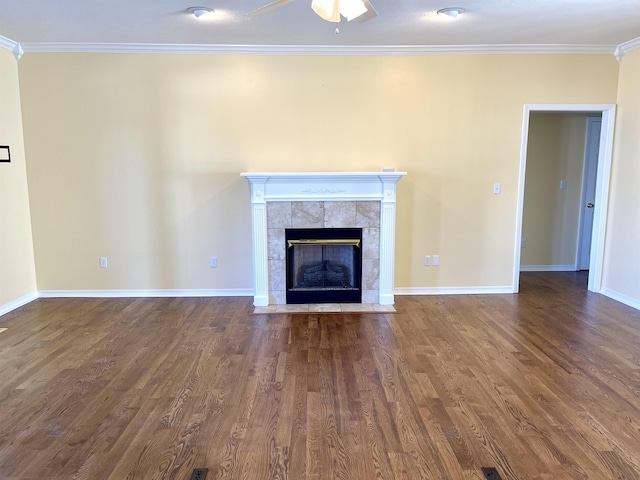 unfurnished living room featuring ceiling fan, ornamental molding, dark hardwood / wood-style floors, and a tile fireplace