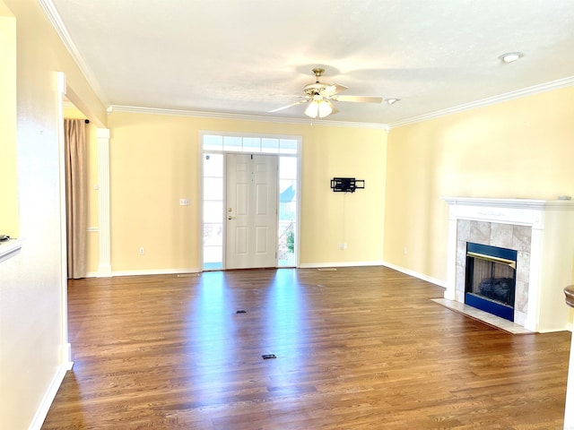 unfurnished living room with crown molding, a fireplace, dark hardwood / wood-style flooring, and ceiling fan