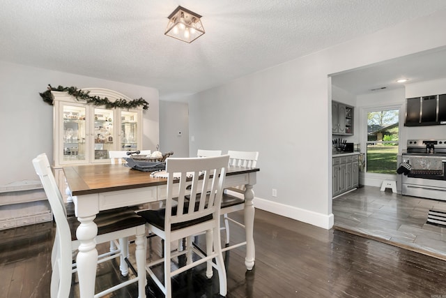 dining space with a textured ceiling and hardwood / wood-style floors