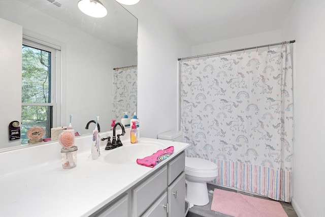 bathroom featuring vanity and toilet