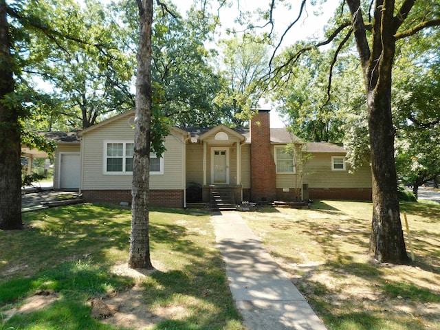 ranch-style home with a garage and a front yard