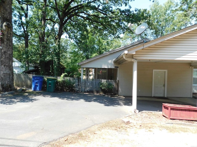 view of property exterior featuring a carport