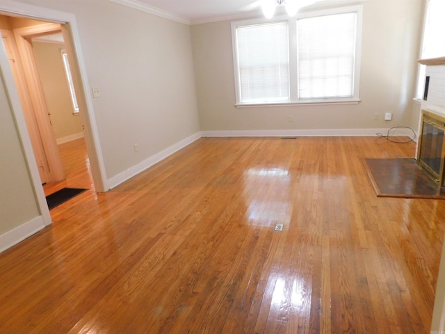 interior space with crown molding and light hardwood / wood-style floors