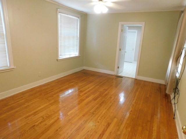 empty room featuring ceiling fan and light wood-type flooring