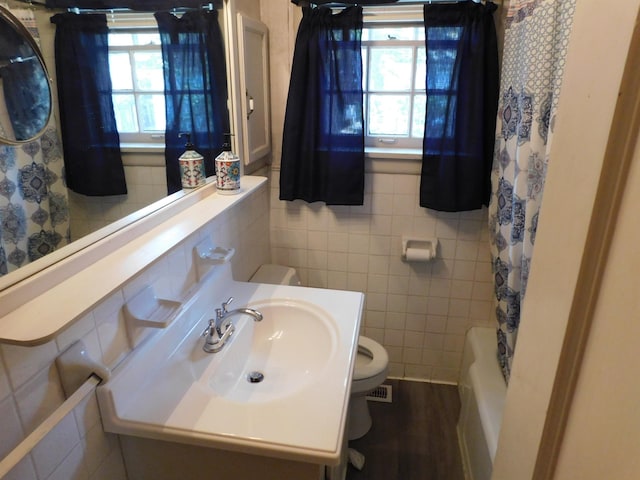 full bathroom featuring tile walls, vanity, shower / bath combo, and toilet