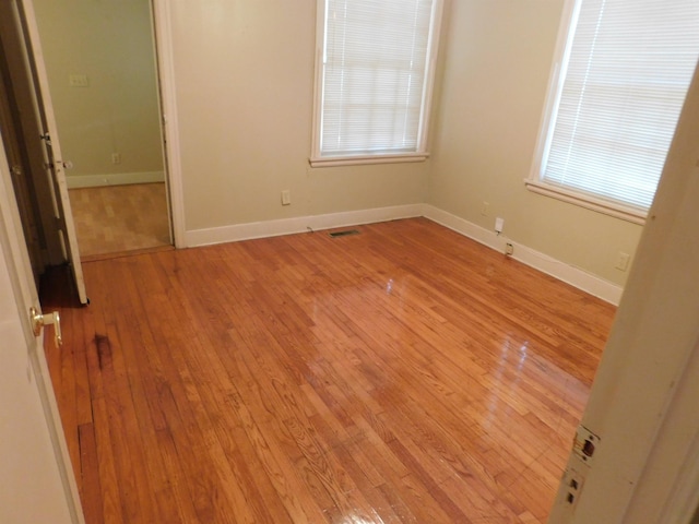 spare room featuring light hardwood / wood-style flooring