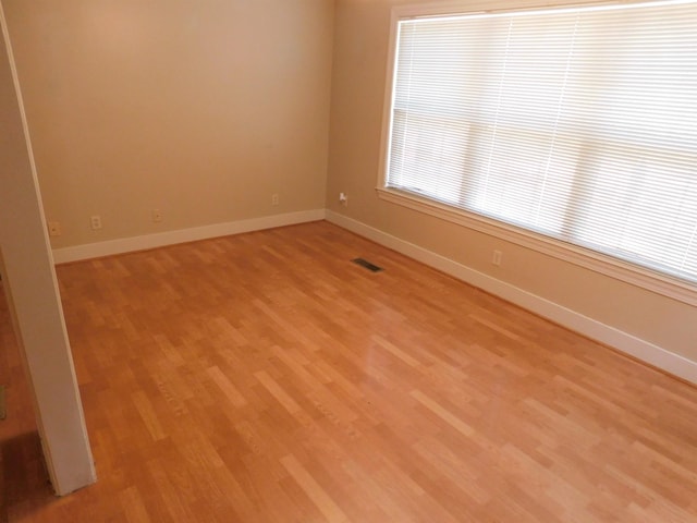 unfurnished room with light wood-type flooring