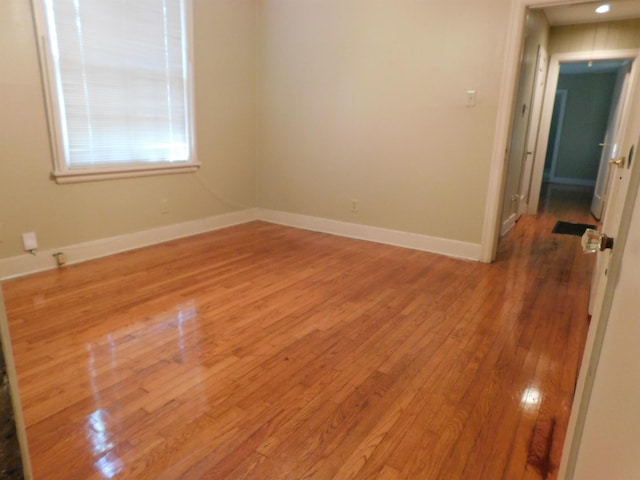 unfurnished room featuring hardwood / wood-style flooring