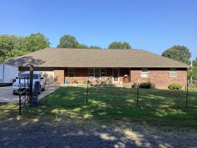 single story home featuring covered porch, a garage, and a front lawn