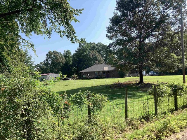 view of yard with a rural view