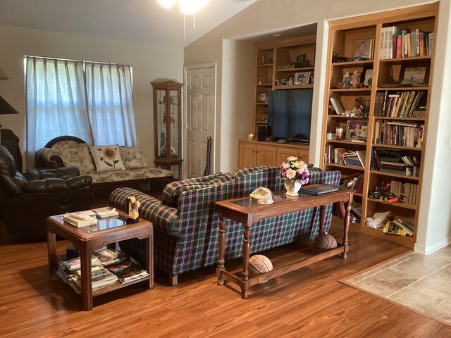 living room with lofted ceiling and hardwood / wood-style floors