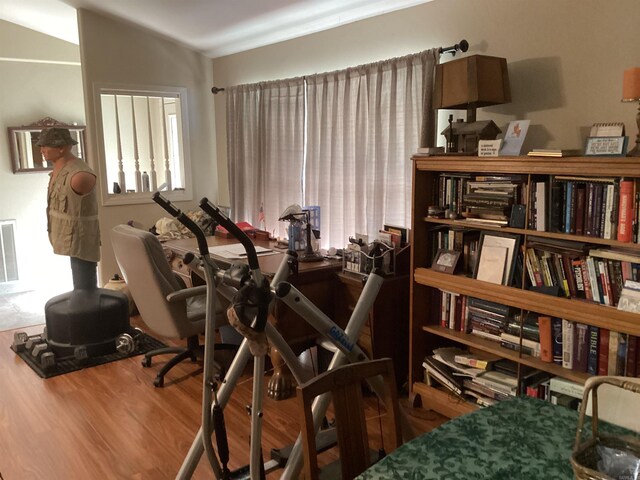 office with lofted ceiling and hardwood / wood-style floors