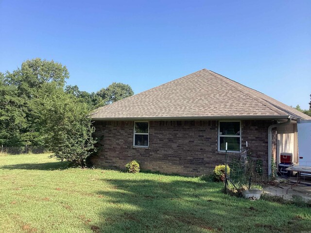 view of side of property with a yard