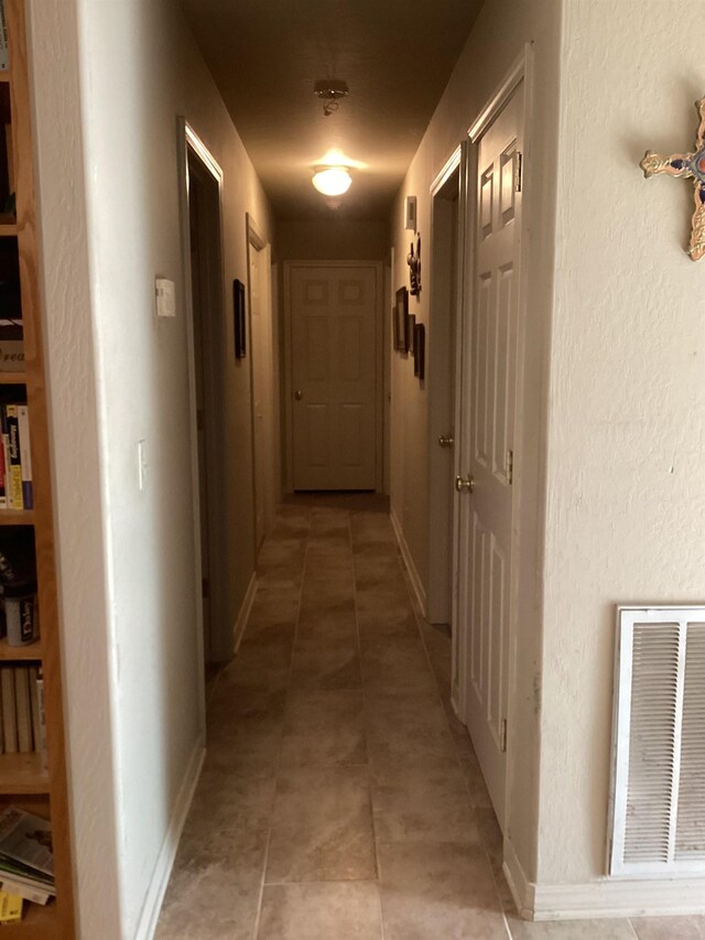 hallway featuring light tile patterned floors