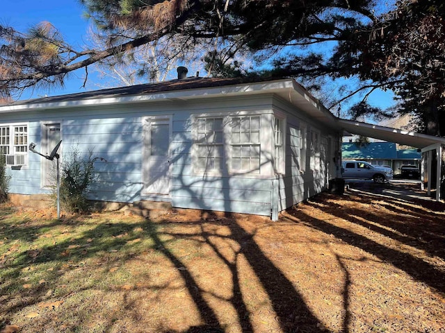 view of side of property with a carport