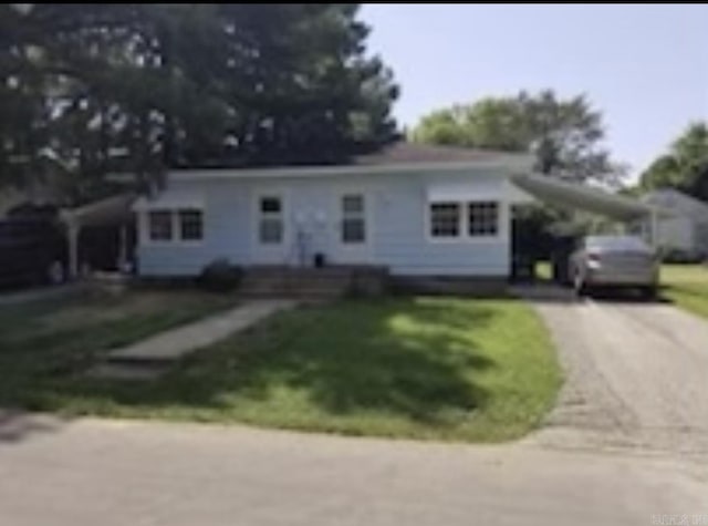 1107 Reynolds St, Clarksville, AR 72830 - ranch-style house featuring concrete driveway, a front lawn, and an attached carport
