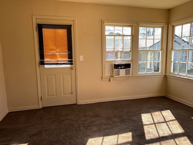 doorway to outside featuring a healthy amount of sunlight and dark colored carpet