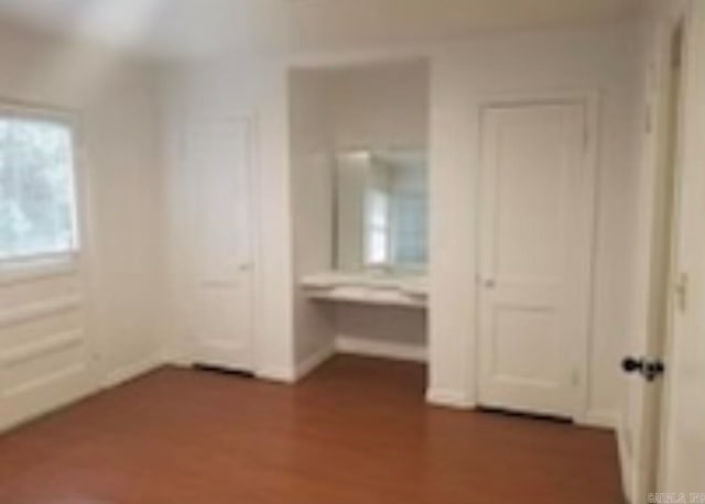 unfurnished bedroom with hardwood / wood-style floors