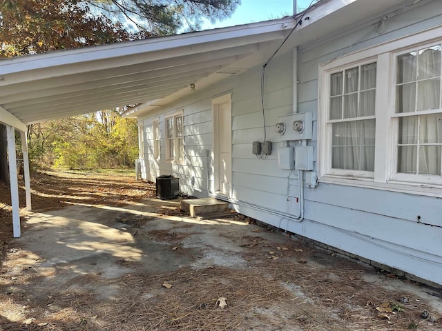 1107 Reynolds St, Clarksville, AR 72830 - view of patio featuring cooling unit and a carport