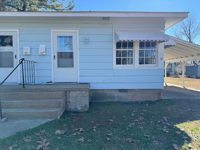 doorway to property with a carport