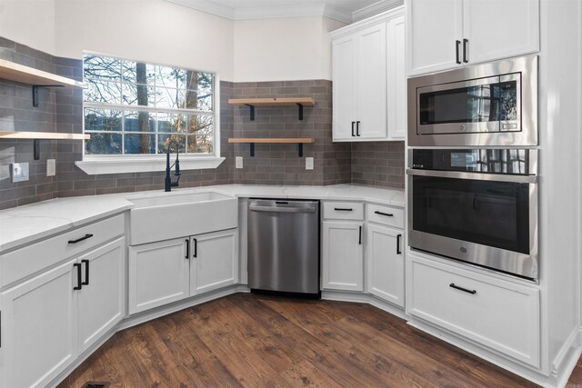 kitchen featuring white cabinetry, tasteful backsplash, dark hardwood / wood-style floors, stainless steel appliances, and light stone countertops