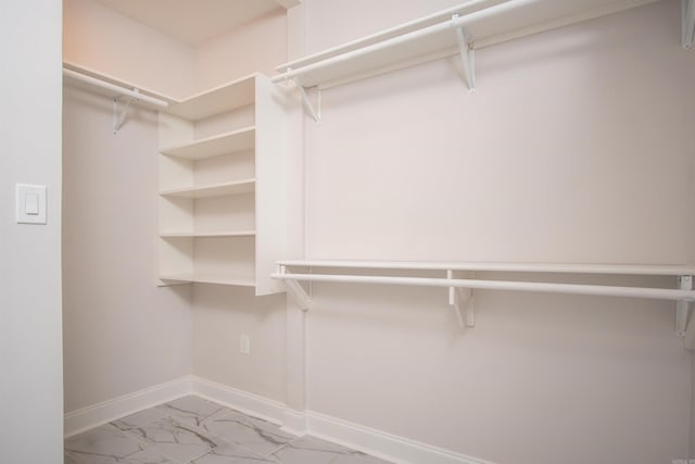 spacious closet with light tile patterned floors