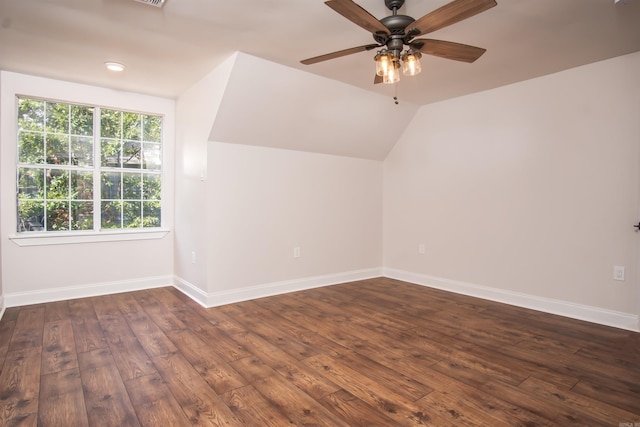 bonus room with ceiling fan, vaulted ceiling, and dark wood-type flooring