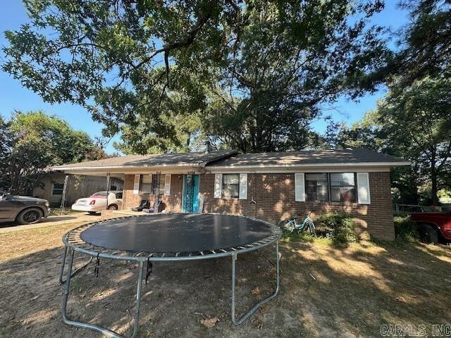 back of house featuring a trampoline