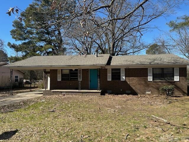 single story home featuring brick siding, concrete driveway, crawl space, an attached carport, and a front lawn