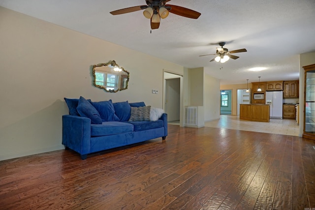 living room featuring tile patterned flooring and ceiling fan