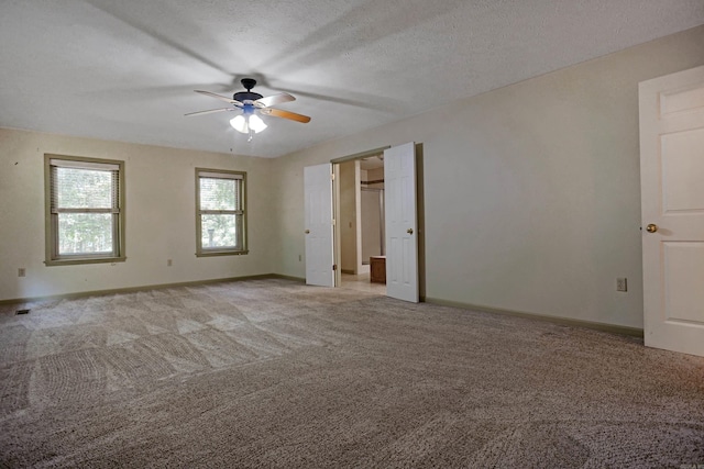 interior space with light carpet, a textured ceiling, and ceiling fan