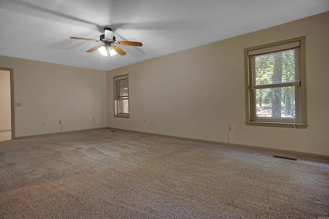 empty room featuring light colored carpet and ceiling fan