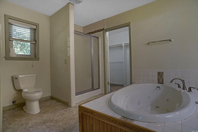 bathroom featuring plus walk in shower, toilet, and a textured ceiling