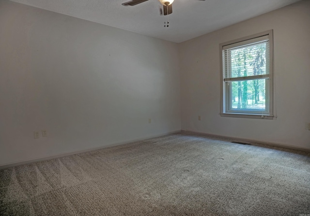 carpeted empty room with ceiling fan