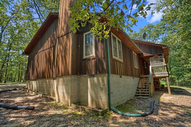 view of side of property featuring a wooden deck