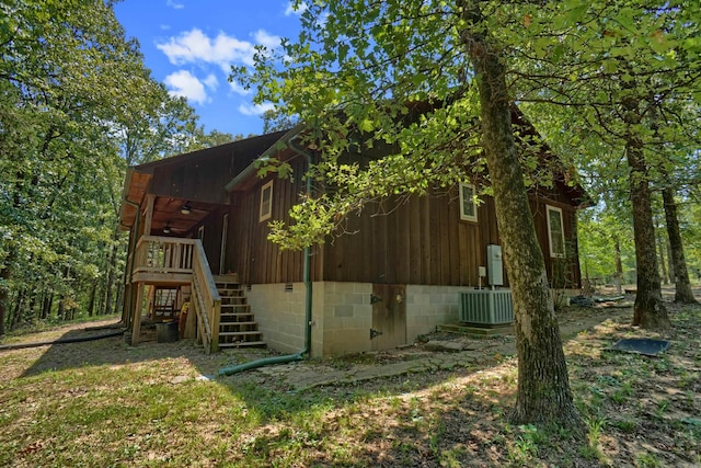 view of side of home featuring a deck and central AC