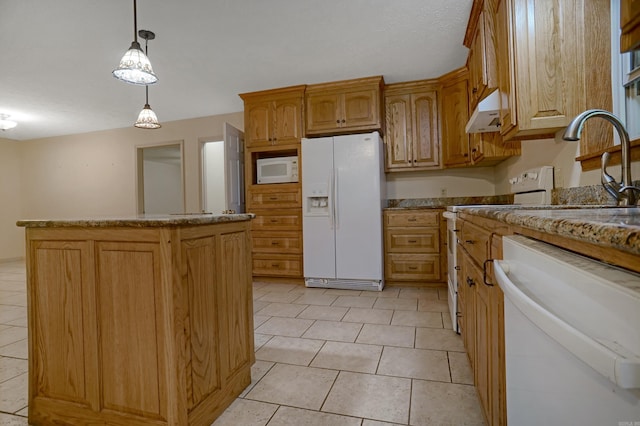 kitchen with light tile patterned flooring, pendant lighting, white appliances, sink, and a center island