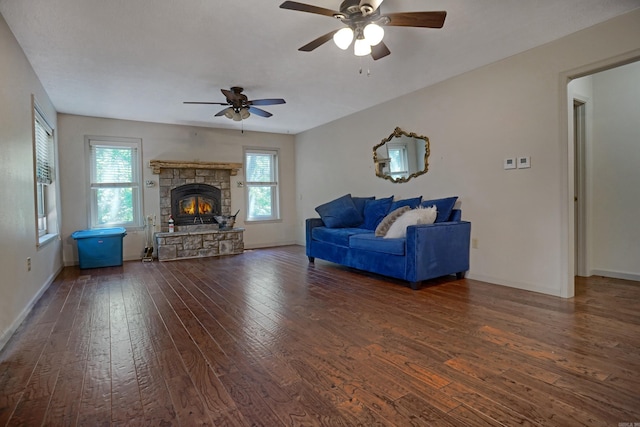 living room featuring ceiling fan, a fireplace, and hardwood / wood-style flooring