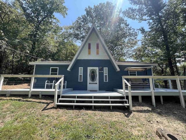 back of house with a yard and a deck