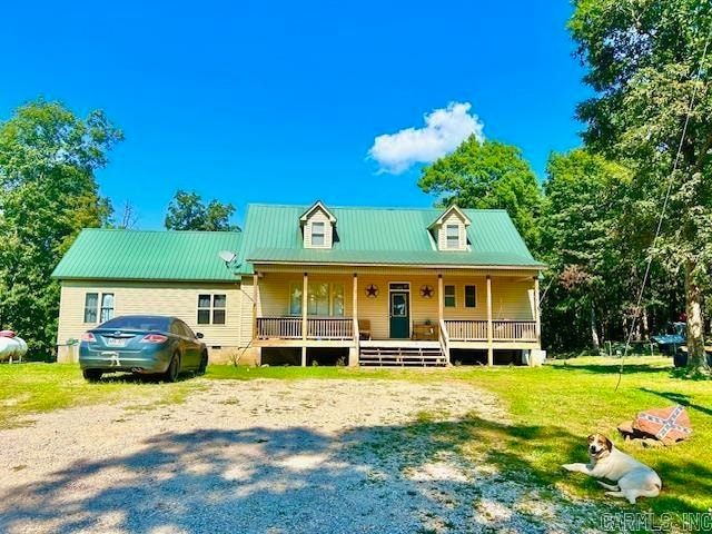 view of front of property with a porch and a front lawn