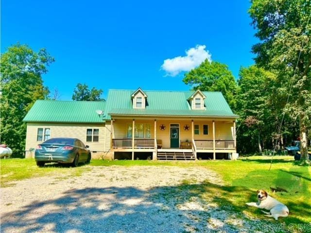 1334 Sutterfield Rd, Fox, AR 72051 - view of front of house featuring a porch, metal roof, and a front lawn