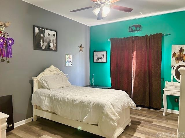 bedroom with light wood-type flooring and ceiling fan