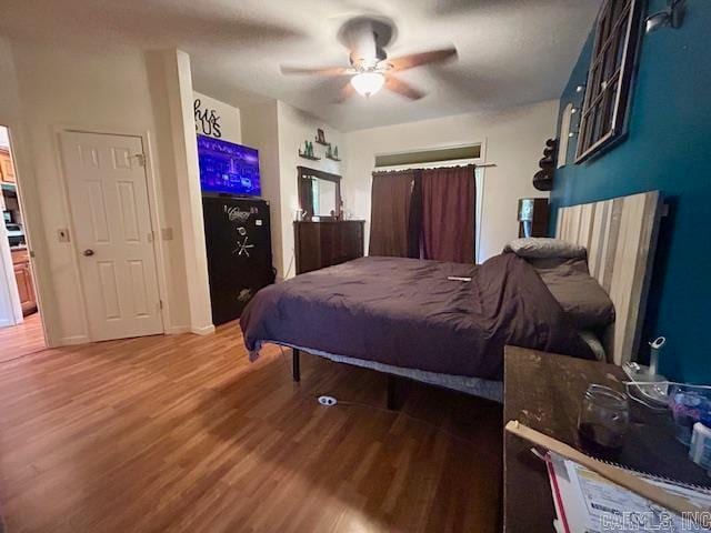 bedroom with wood-type flooring and ceiling fan