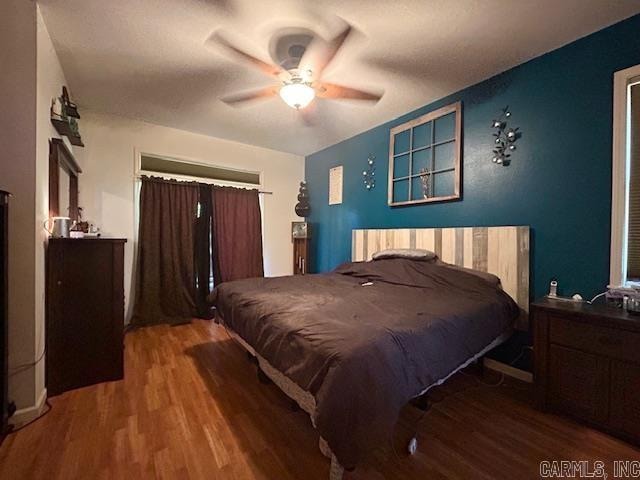 bedroom featuring ceiling fan and wood-type flooring