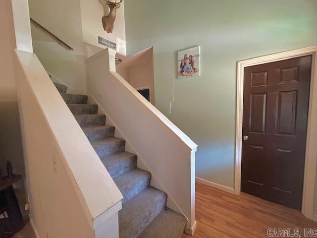 staircase with wood-type flooring