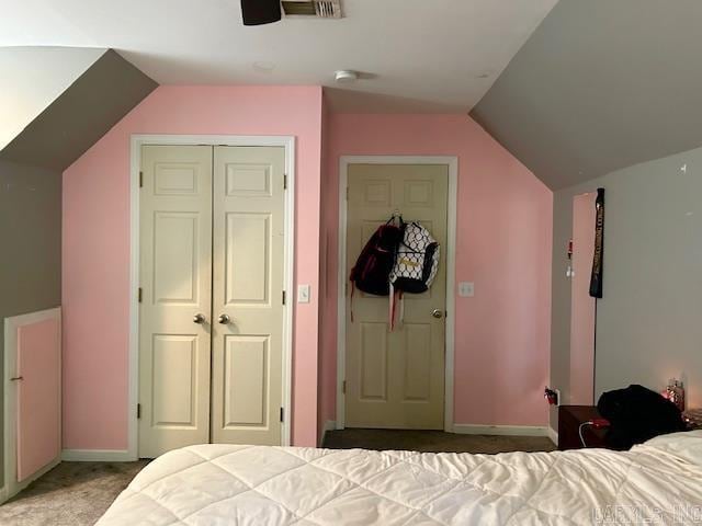 carpeted bedroom with lofted ceiling, a closet, and ceiling fan