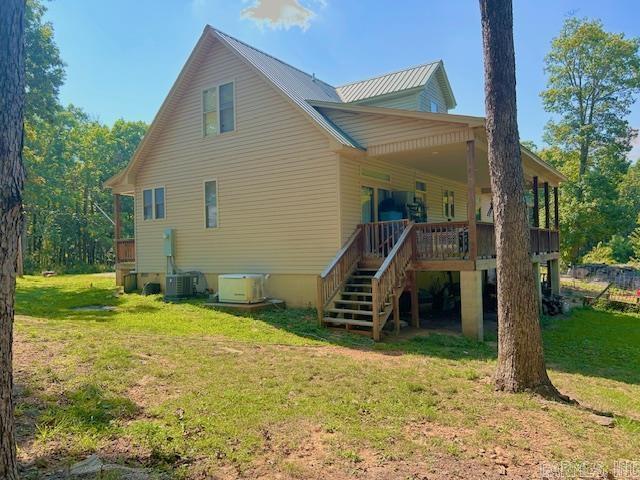 1334 Sutterfield Rd, Fox, AR 72051 - back of house featuring a yard, stairs, central AC unit, and metal roof